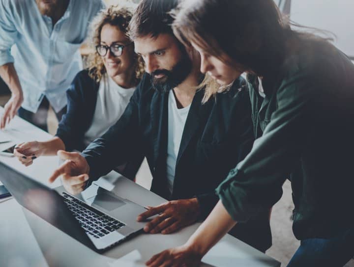 Team Pointing At Laptop