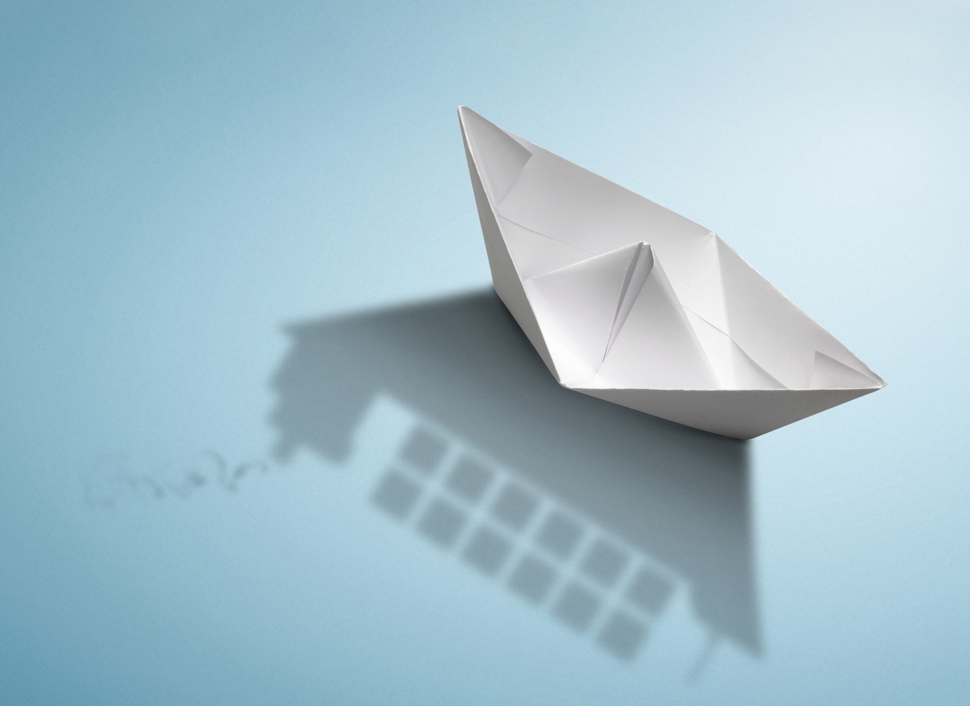 Paperboat on blue